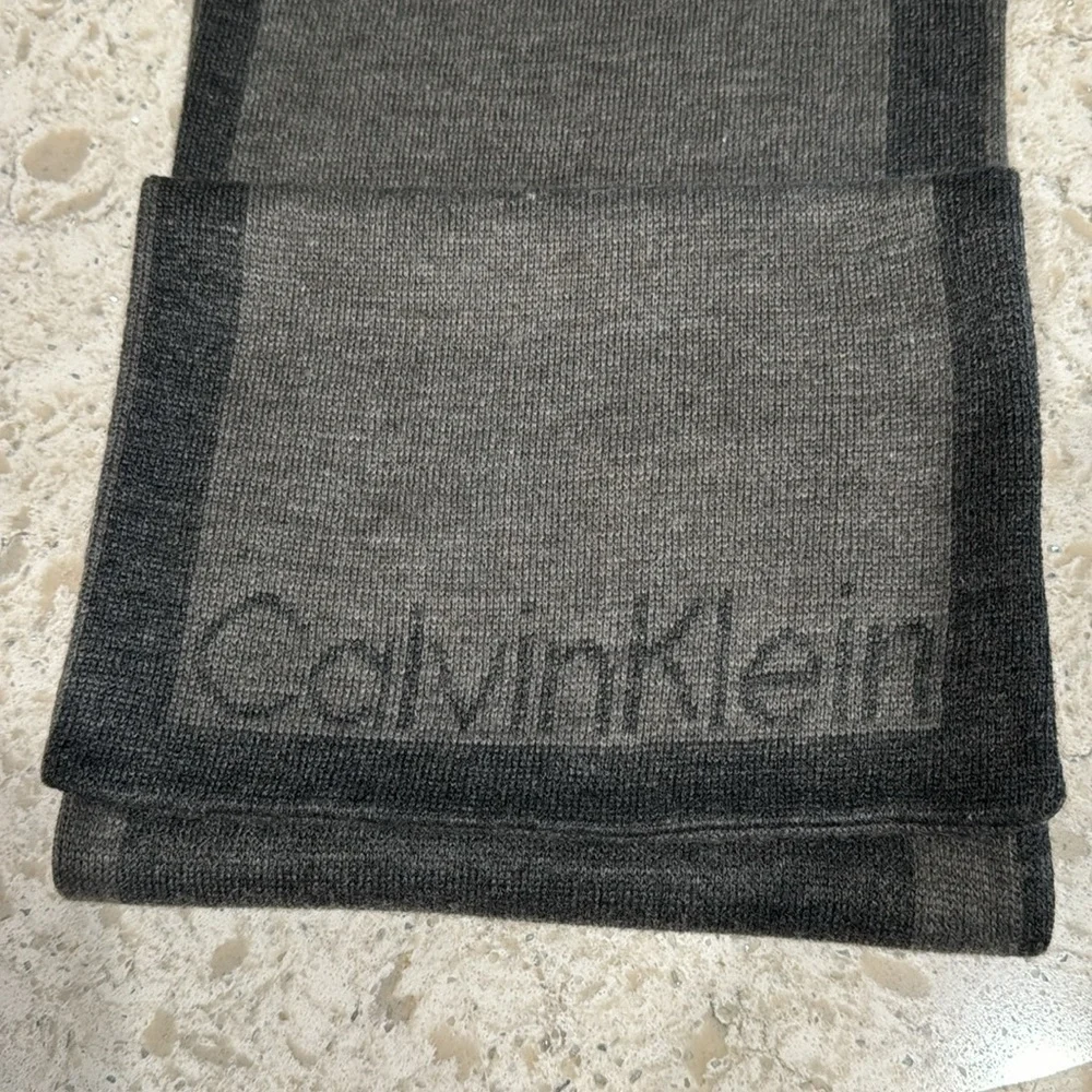 CALVIN KLEIN~CHARCOAL GRAY WITH DARK GRAY BORDER & LOGO AT BOTTOM OF SCARF~UEC